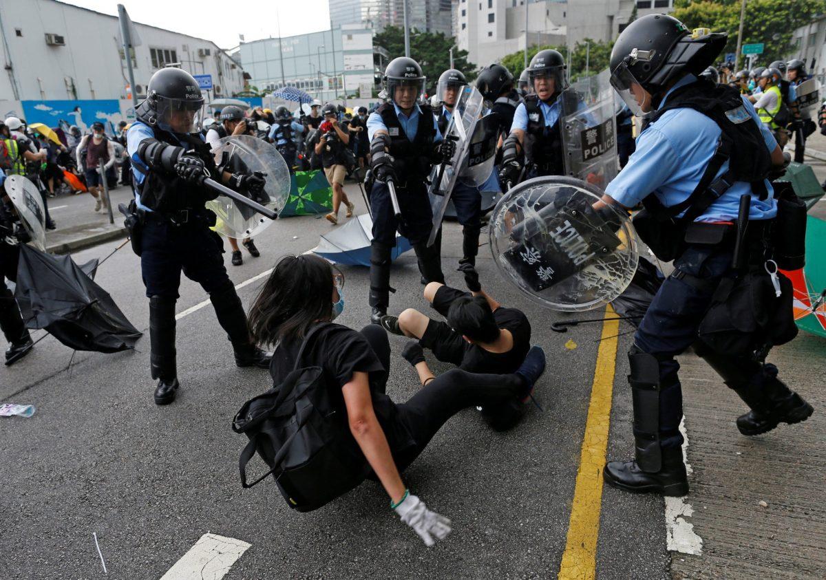 Riot police try to disperse protesters near a flag raising ceremony for the anniversary of Hong Kong handover to China in Hong Kong, China on July 1, 2019. (Thomas Peter/Reuters)