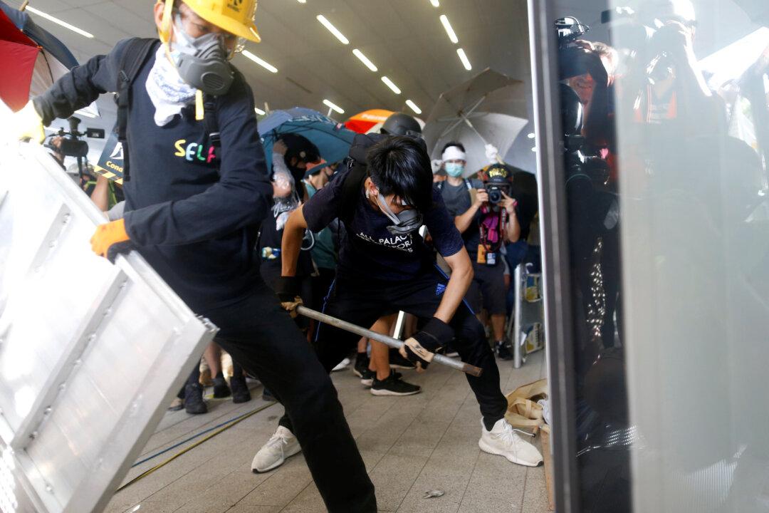 Hong Kong Protesters Storm Into Legislature Building, Smashing up Doors and Walls