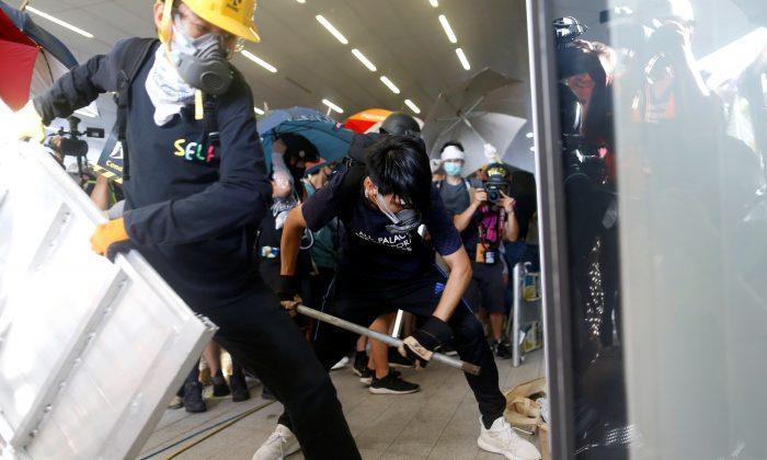 Hong Kong Protesters Storm Into Legislature Building, Smashing up Doors and Walls