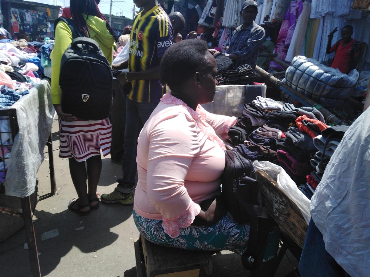 A woman vendor arraning her second-hand clothes at the Gikomba market in Nairobi, Kenya, on June 19, 2019. (Dominic Kirui/The Epoch Times)