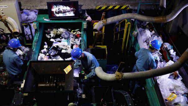 Workers sort out plastic waste for recycling at Minato Resource Recycle Center in Tokyo, Japan on June 10, 2019. (Kim Kyung-Hoon/Reuters)