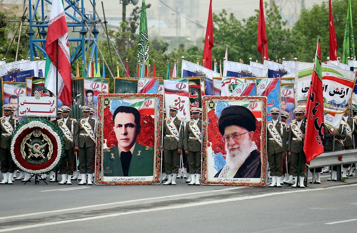 Iranian soldiers hold posters of Iranian Supreme leader Ayatollah Ali Khamenei (R) and former chief of staff of Iranian Army Sepahbod Mohammad-Vali Gharani (L) as they march during a military parade as they mark the country's annual army day in Tehran, on April 18, 2019. (Stringer/AFP/Getty Images)