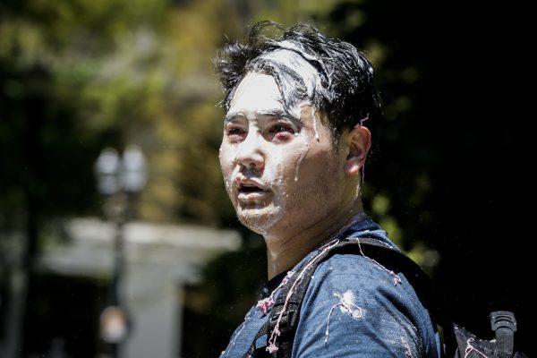 Andy Ngo, a Portland-based journalist, is seen covered in unknown substance after unidentified Rose City Antifa members attacked him on June 29, 2019 in Portland, Oregon. Several groups from the left and right clashed after competing demonstrations at Pioneer Square, Chapman Square, and Waterfront Park spilled into the streets. According to police, medics treated eight people and three people were arrested during the demonstrations. (Moriah Ratner/Getty Images)