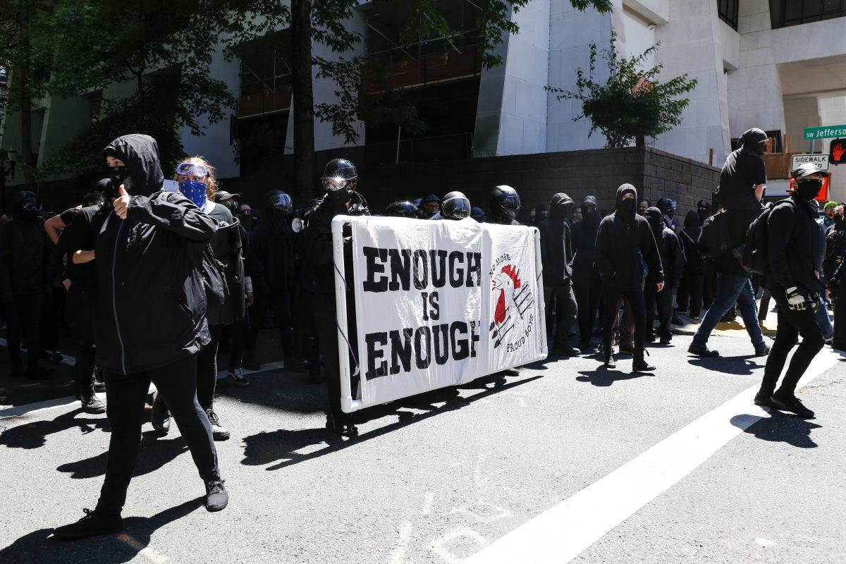 The Rose City Antifa prepare to march in opposition to members of HimToo and Proud Boys in Portland, Oregon, on June 29, 2019. Several groups from the left and right clashed after competing demonstrations at Pioneer Square, Chapman Square, and Waterfront Park spilled into the streets. According to police, medics treated eight people and three people were arrested during the demonstrations. (Moriah Ratner/Getty Images)