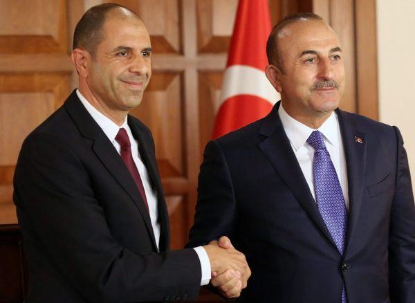 Turkish Foreign Minister Mevlut Cavusoglu (R) shakes hands with his Deputy Prime Minister of the Turkish Republic of Northern Cyprus and Minister of Foreign Affairs Kudret Ozersay at the end of a joint press conference following their meeting in Ankara, Turkey on Sept. 3, 2018. (ADEM ALTAN/AFP/Getty Images)