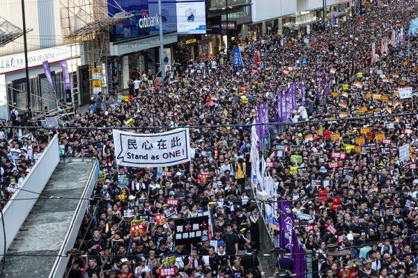 Protesters march on Hong Kong streets during the annual rally on July 1, 2019. (Yu Gang/The Epoch Times)