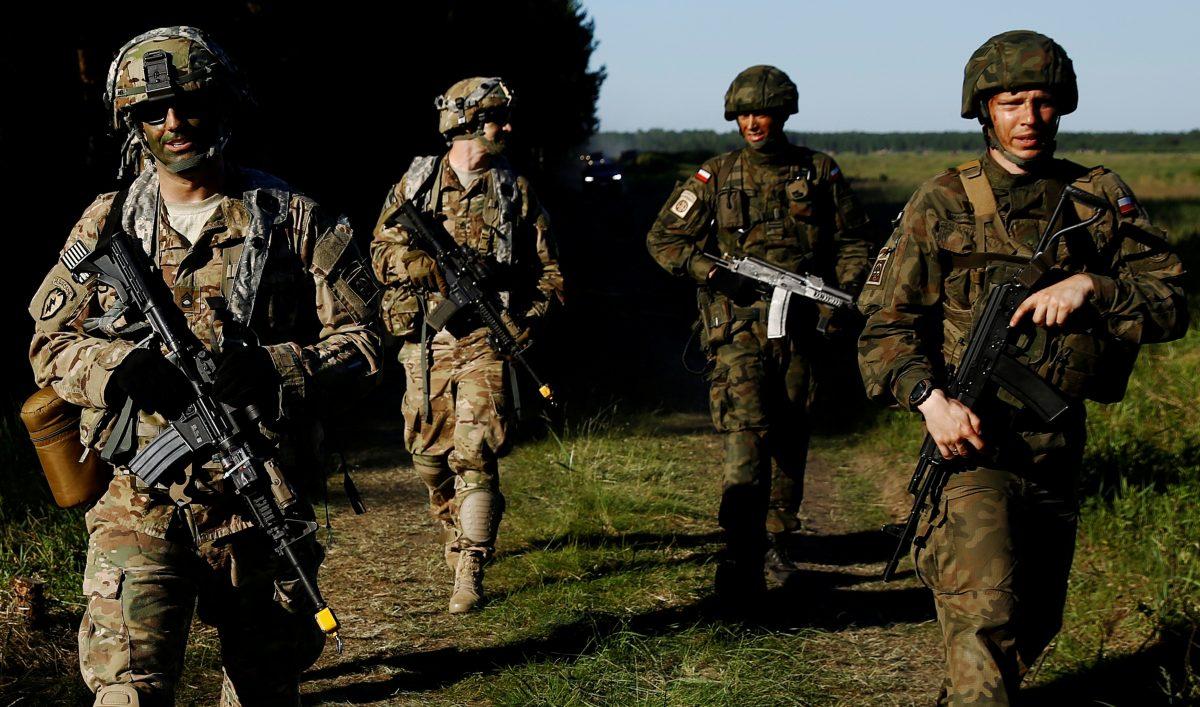 Poland's 6th Airborne Brigade soldiers walk with U.S. 82nd Airborne Division soldiers during the NATO allies' Anakonda 16 exercise near Torun, Poland, on June 7, 2016. (Kacper Pempel/Reuters)