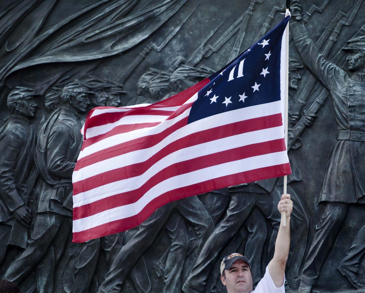 A protester holds a version of the Betsy Ross American flag during the Tea Party Express rally in Washington on Sept. 12, 2009. (Brendan Smialowski/Getty Images)