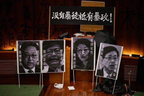 Placards of Hong Kong's Chief Executive Carrie Lam (2nd L), Secretary for Security John Lee (R) and Secretary of Justice Teresa Cheng (2nd L) are seen after protesters stormed the government headquarters hours before in Hong Kong early on July 2, 2019. (ANTHONY WALLACE/AFP/Getty Images)