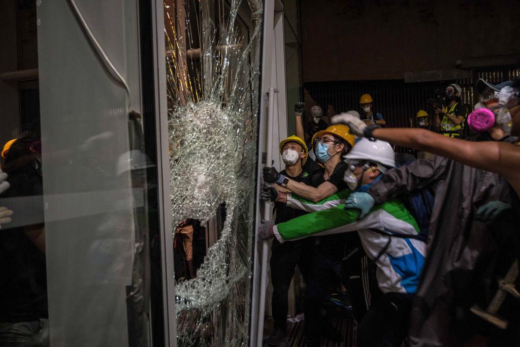 Protesters smash glass doors and windows to break into the parliament chamber of Legislative Council Complex protest against the extradition bill in Hong Kong on July 1, 2019. (Billy H.C. Kwok/Getty Images)