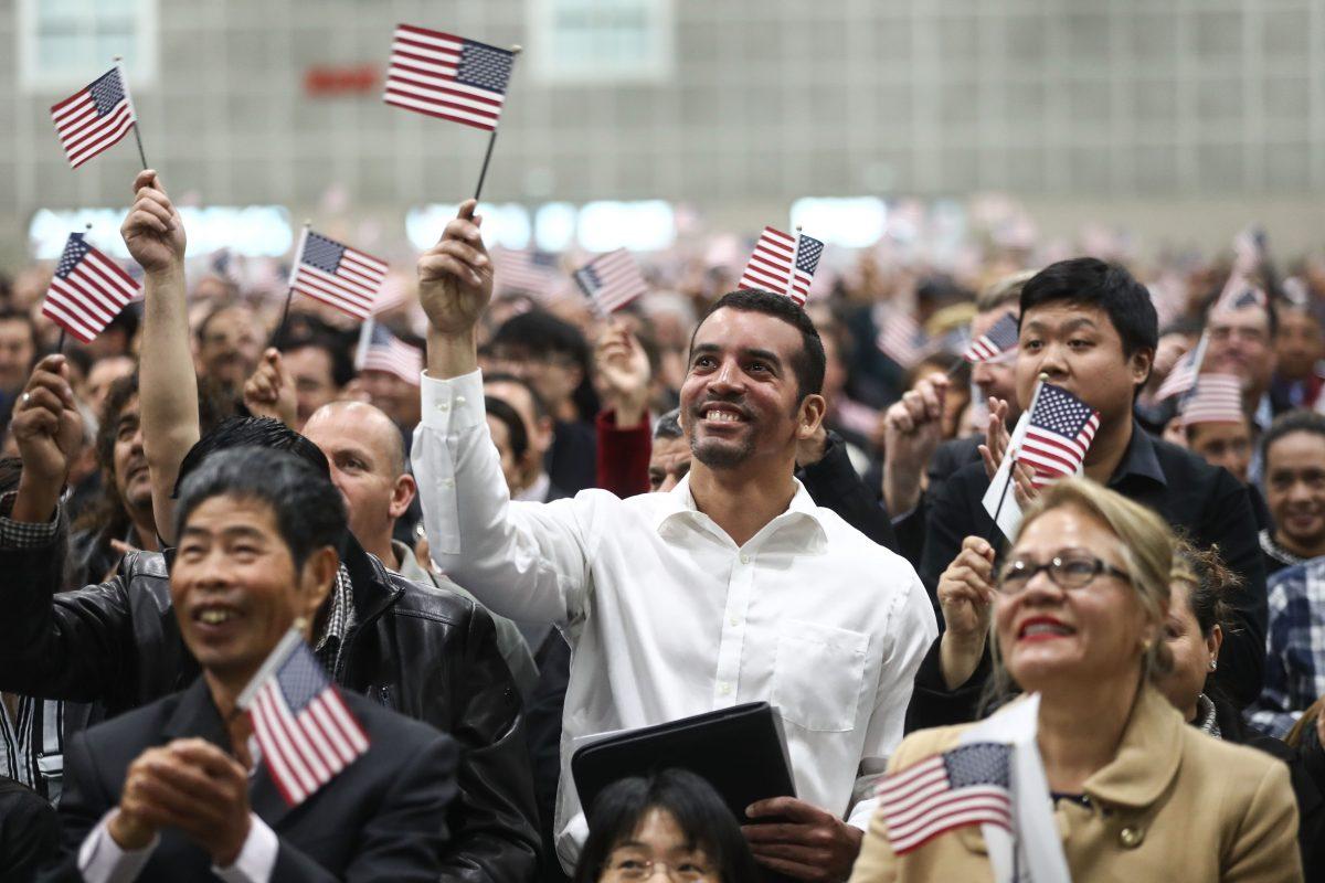 New U.S. citizens wave American flags at a naturalization ceremony in Los Angeles on March 20, 2018. (Mario Tama/Getty Images)