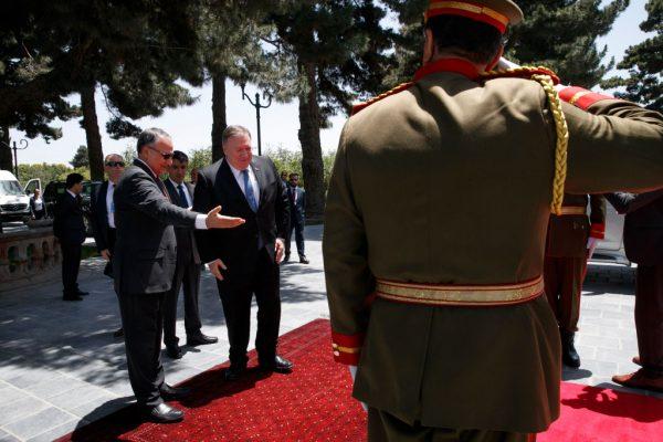 Secretary of State Mike Pompeo center, is welcomed to the Presidential Palace in Kabul, Afghanistan, by Afghan President Ashraf Ghani's Chief of Staff Abdul Salam Rahimi (L), on June 25, 2019 (JACQUELYN MARTIN/AFP/Getty Images)