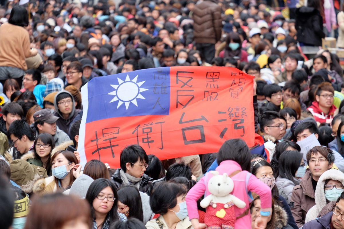 Protesters displays a Taiwan flag with the words "protect Taiwan" on it during ongoing protests by thousands of people outside the parliament in Taipei, Taiwan, on March 22, 2014. (Sam Yeh/AFP/Getty Images)