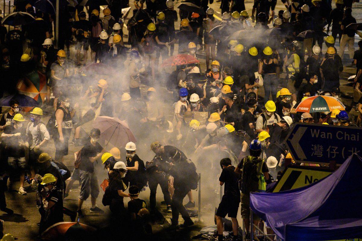 Police fire tear gas at protesters near the government headquarters in Hong Kong early on July 2, 2019. (Anthony Wallace/AFP/Getty Images)