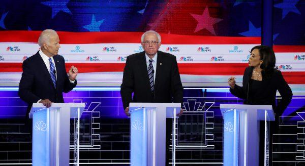 Sen. Kamala Harris (R) (D-CA) and former Vice President Joe Biden (L) speak as Sen. Bernie Sanders (I-VT) looks on during the second night of the first Democratic presidential debate in Miami, Florida on June 27, 2019. (Drew Angerer/Getty Images)