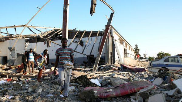 Migrants carry the remains of their belongings from among rubble at a detention center for mainly African migrants that was hit by an airstrike in the Tajoura suburb of the Libyan capital of Tripoli, Libya on July 3, 2019. (Ismail Zitouny/Reuters)