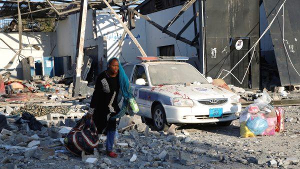 A migrant picks up her belongings from among rubble at a detention center for mainly African migrants that was hit by an airstrike in the Tajoura suburb of the Libyan capital of Tripoli, Libya on July 3, 2019. (Ismail Zitouny/Reuters)