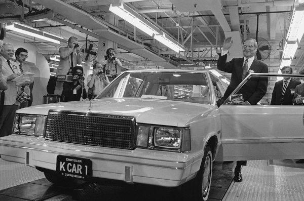 Chrysler Chairman Lee Iacocca, right, waves as he steps into the first K-Car at ceremonies in Detroit, Mich., on Aug. 6, 1980. (Dale Atkins/AP Photo)