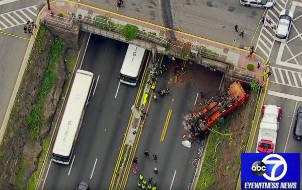 First responders work the scene after a garbage truck careened off an overpass onto the westbound lanes of Route 495, in Union City, N.J., on July 3, 2019. (WABC-TV via AP)