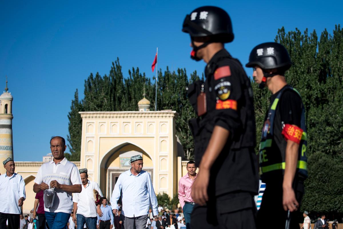 Police patrolling as Muslims leave the Id Kah Mosque after the morning prayer on Eid al-Fitr in Kashgar, Xinjiang, China, on June 26, 2017. (Johannes Eisele/AFP/Getty Images)