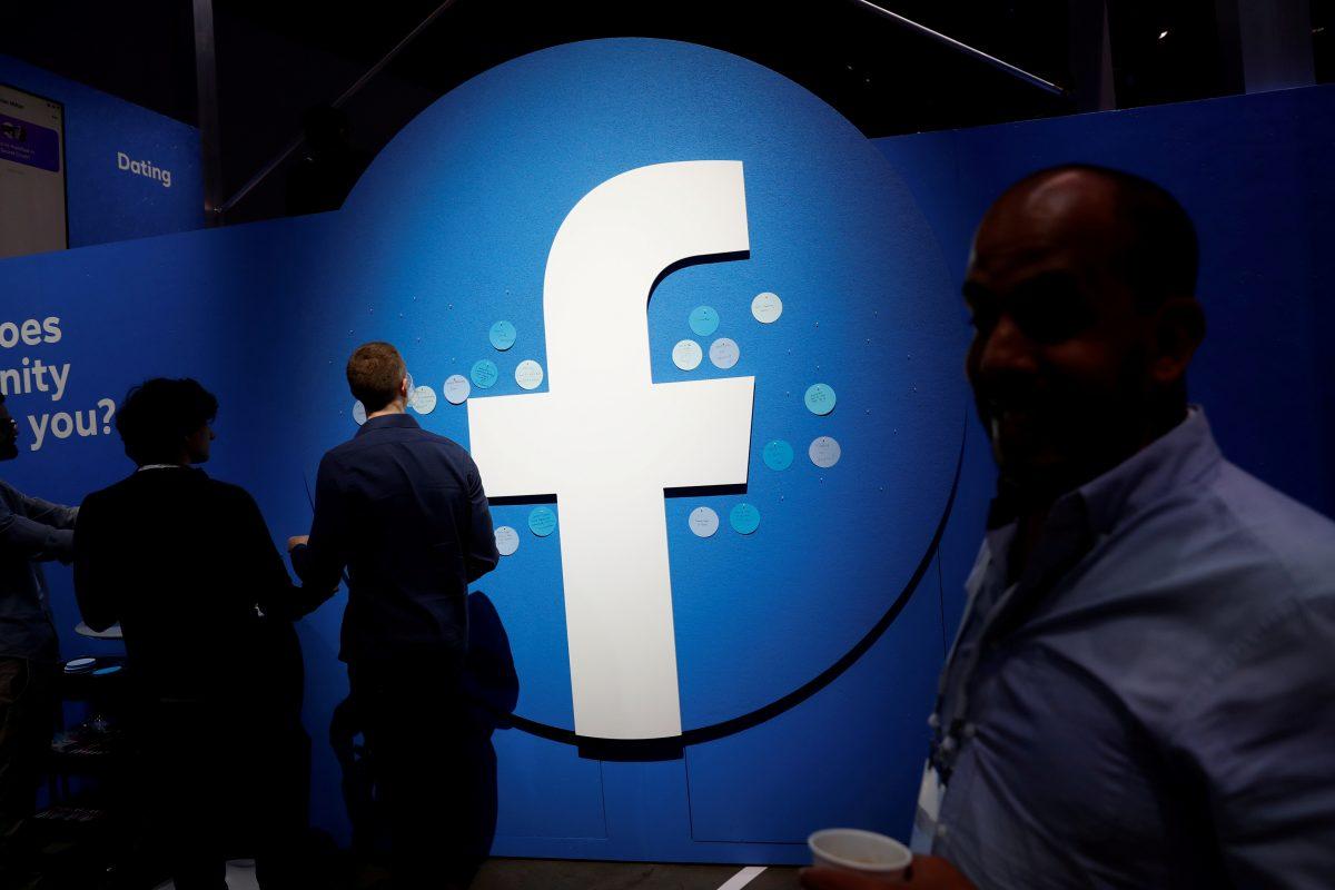 Attendees walk past a Facebook logo during Facebook Inc's F8 developers conference in San Jose, Calif., on April 30, 2019. (Stephen Lam/File Photo via Reuters)