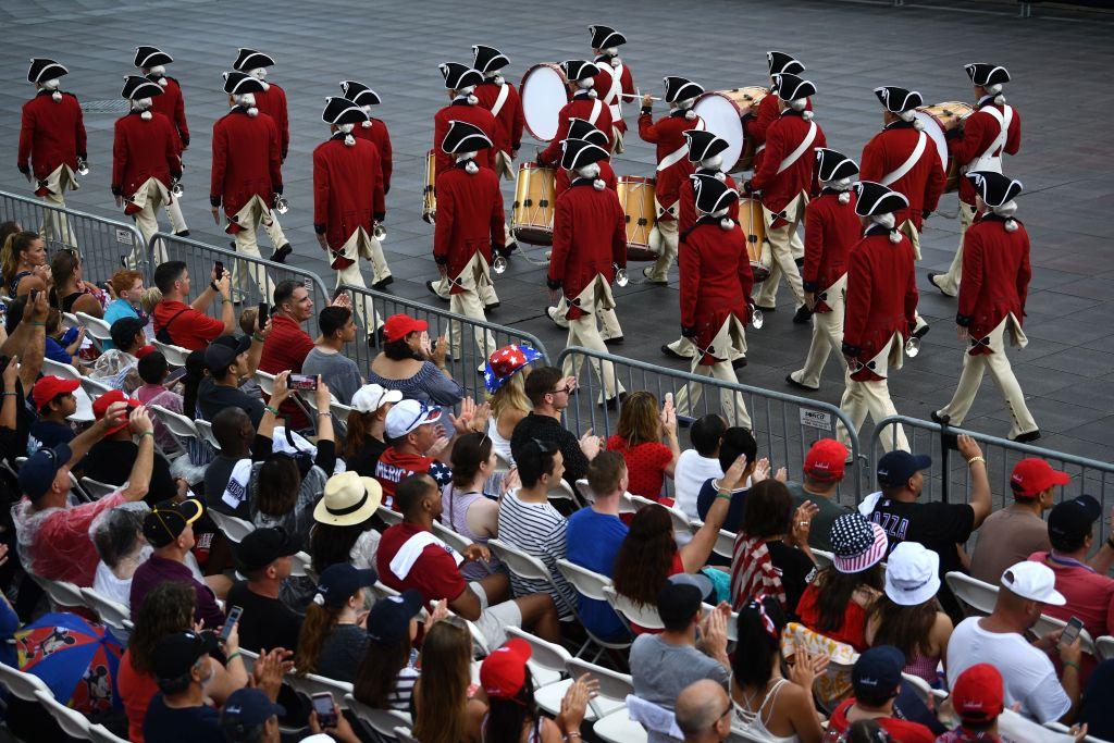 People watch a marching band perform on the National Mall ahead of the "Salute to America" Fourth of July event with US President Donald Trump at the Lincoln Memorial in Washington on July 4, 2019. (Brendan Smialowski / AFP)