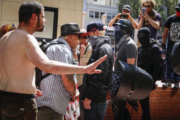 A man who was later assaulted by Antifa, second from left, faces off with Rose City Antifa members at Pioneer Courthouse Square in Portland, Oregon, on June 29, 2019. (Moriah Ratner/Getty Images)