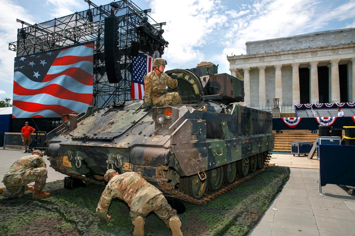 An Army soldier hops out of a Bradley Fighting Vehicle after moving it into place by the Lincoln Memorial in Washington on July 3, 2019. (Jacquelyn Martin/AP Photo)