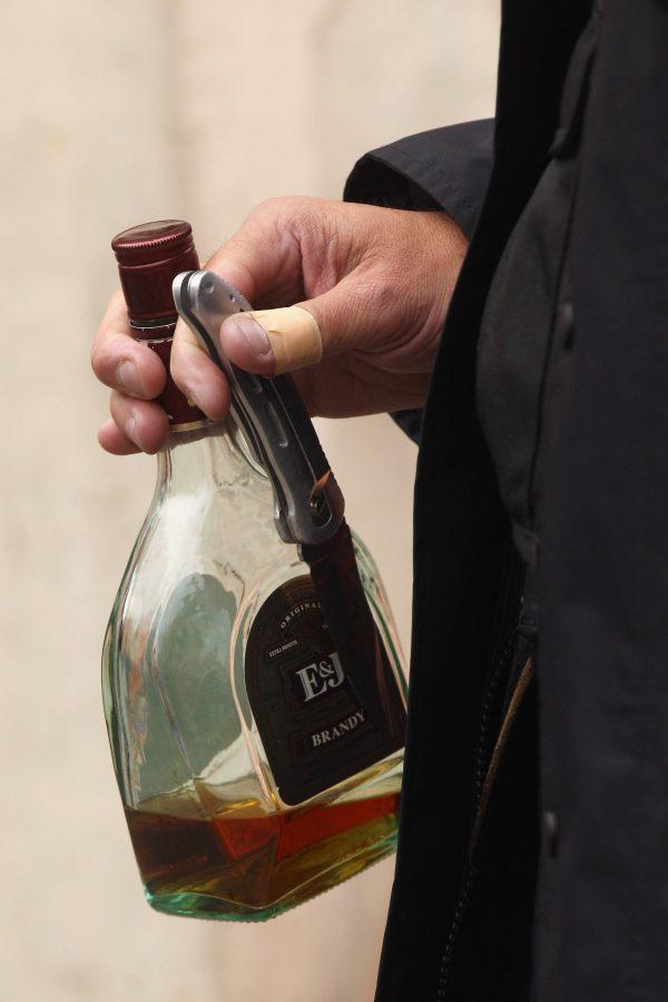 A police officer holds a knife and bottle of brandy recovered from near to where a man was stabbed in the stomach at the Notting Hill Carnival in London, England, on Aug. 29, 2011. (Oli Scarff/Getty Images)