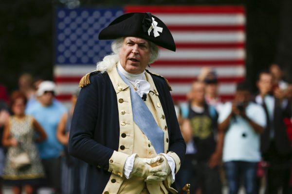 Historical re-enactor Dean Malissa, as George Washington, inspects troops during a July 4th event, An American Celebration, at Mount Vernon, Va., on July 4, 2019. (Samira Bouaou/The Epoch Times)