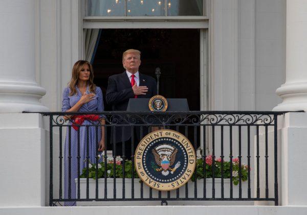President Donald Trump and First Lady Melania Trump stand for the National Anthem during a picnic for military families on the South Lawn of the White House in Washington on July 4, 2018. (Alex Edelman/Getty Images)