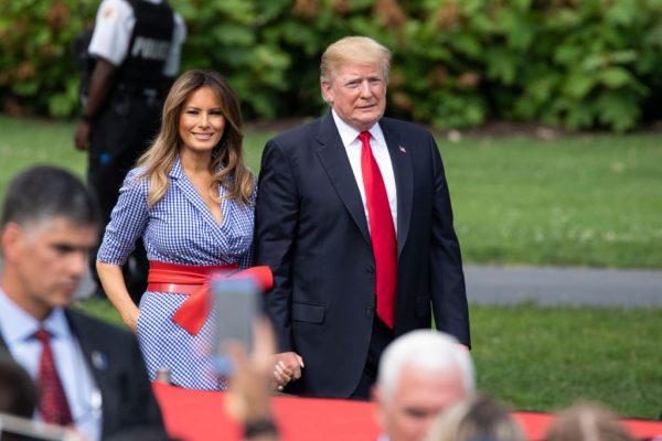 President Donald Trump and First Lady Melania Trump walk on the South Lawn of the White House prior to greeting guests during a picnic for military families on at the White House in Washington on July 4, 2018. (Alex Edelman/Getty Images)