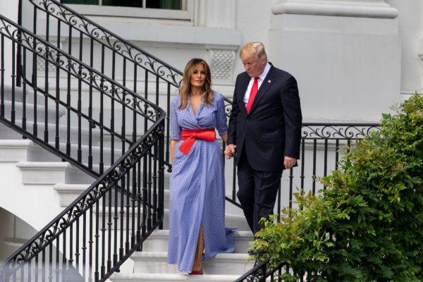 President Donald Trump and First Lady Melania Trump walk down the White House steps prior to greeting guests during a picnic for military families on the South Lawn of the White House in Washington on July 4, 2018. (Alex Edelman/Getty Images)