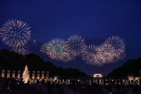 People watch the fireworks display on the National Mall during the Fourth of July festivities in Washington on July 4, 2019. (Stephanie Keith/Getty Images)