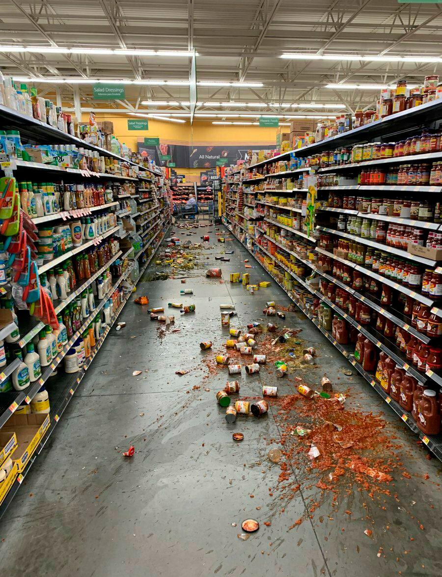 Food that fell from the shelves litters the floor of an aisle at a Walmart following an earthquake in Yucca Yalley, Calif., on July 5, 2019. (Chad Mayes via AP)