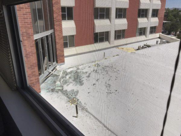 In this photo provided by Raven Green, is damage to a dormitory building with windows blown out and other debris that fell after an explosion at the University of Nevada, Reno on July 5, 2019. (Raven Green via AP)