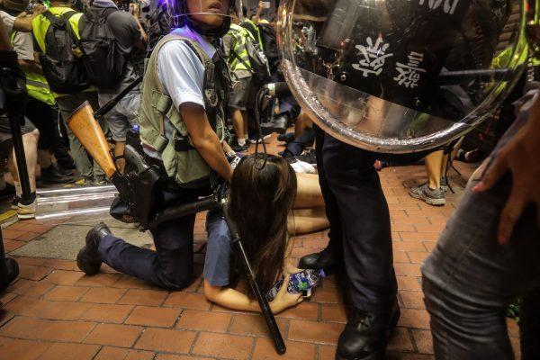 A protester reacts as she is detained during clashes with the police in Mong Kok district after a demonstration at West Kowloon railway station protesting against the proposed extradition bill on July 7, 2019, in Hong Kong. (VIVEK PRAKASH/AFP/Getty Images)