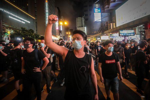 A protester gestures during clashes with the police in Mong Kok district after a demonstration at West Kowloon railway station protesting against the proposed extradition bill on July 7, 2019, in Hong Kong. (VIVEK PRAKASH/AFP/Getty Images)