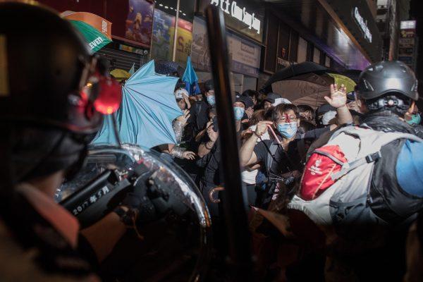 A protester bleeds from a head wound as police charge protesters in the Mong Kok district after a demonstration at West Kowloon railway station protesting against the proposed extradition bill on July 7, 2019. in Hong Kong, China. (Chris McGrath/Getty Images)