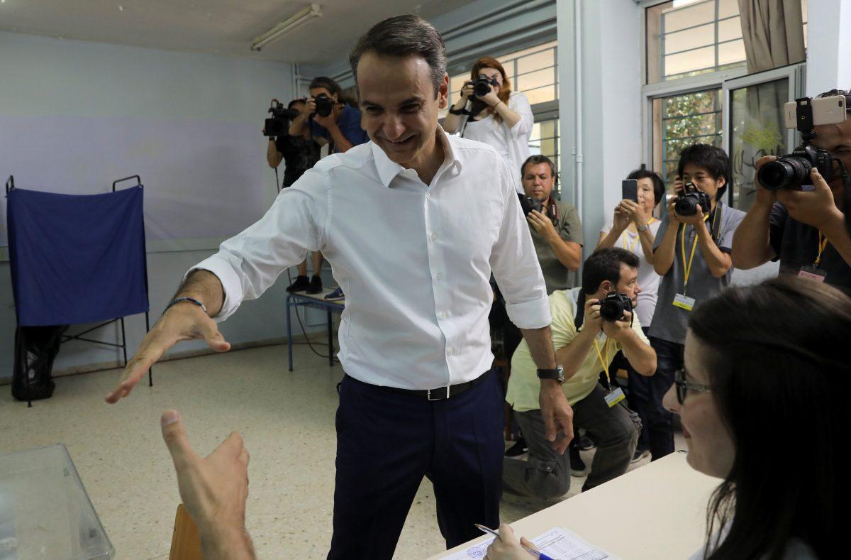 New Democracy conservative party leader Kyriakos Mitsotakis greets election officials at a polling station, during the general election in Athens, Greece, on July 7, 2019. (Alkis Konstantinidis/Reuters)