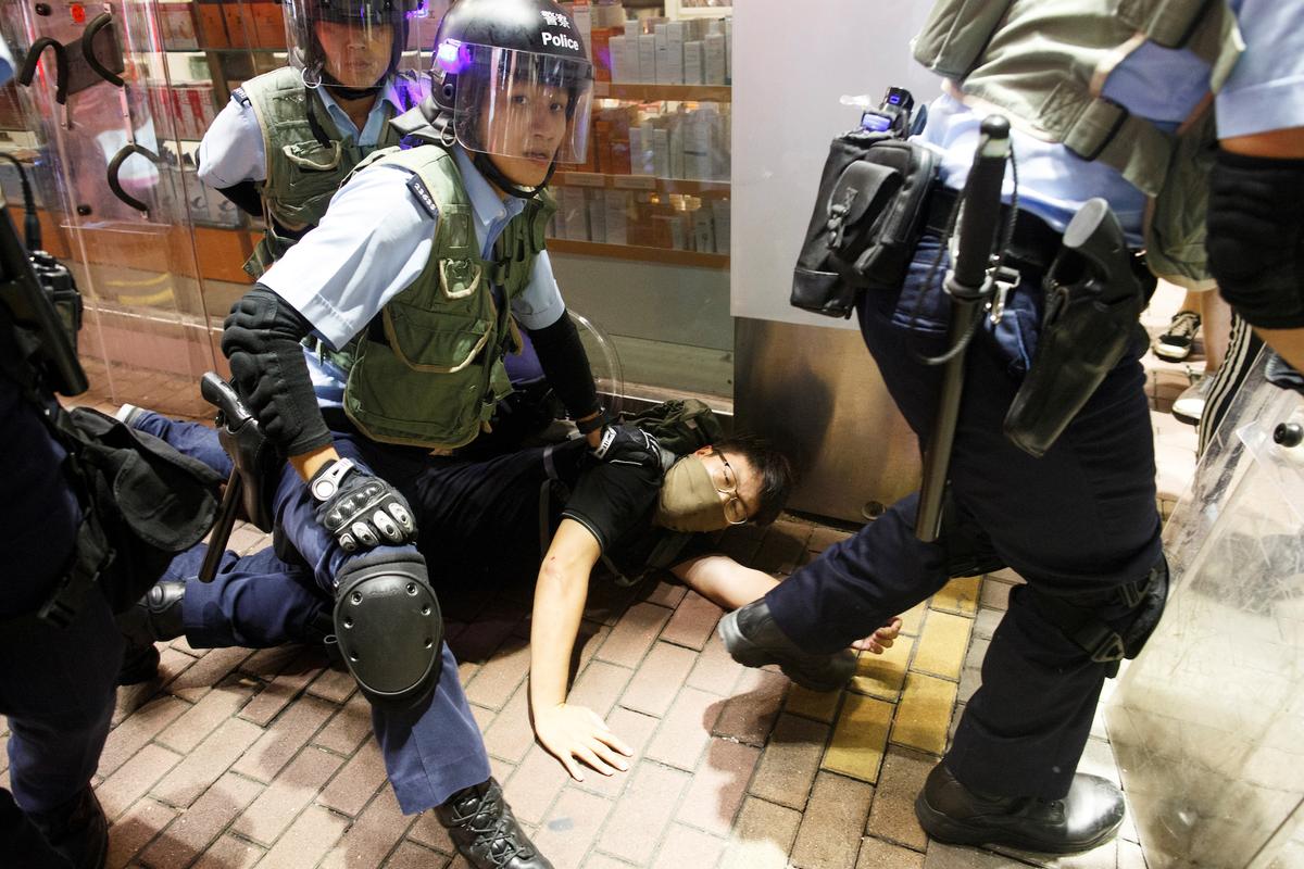 Riot police detain an anti-extradition bill protester after a march at Hong Kong’s tourism district Nathan Road near Mongkok, China on July 7, 2019. (Thomas Peter/Reuters)