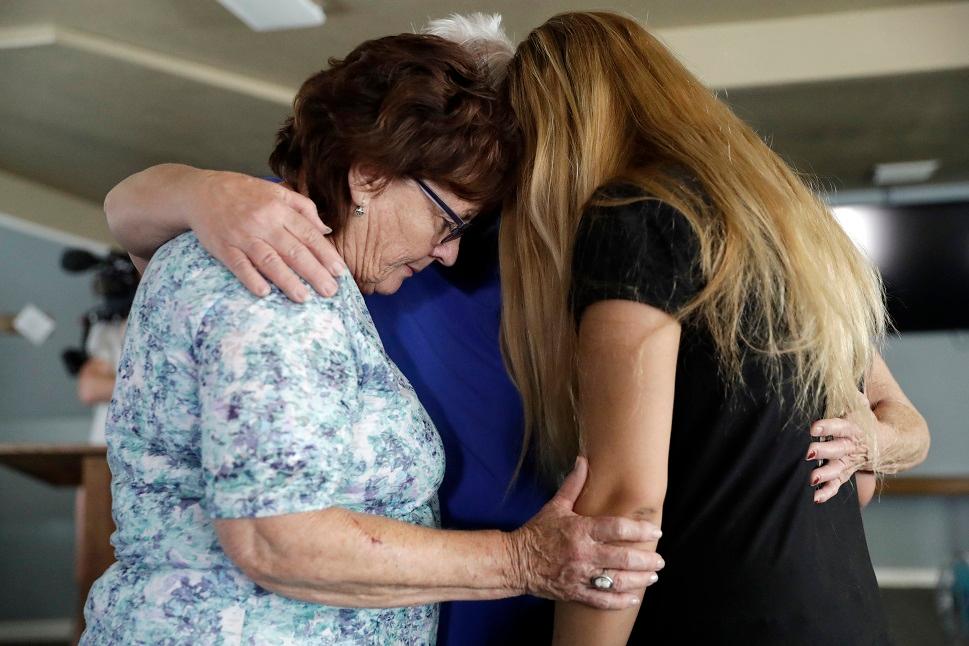 Alexandria Johnson, at right, whose home was damaged by an earthquake, prays with fellow congregants including Sara Smith, left, in the aftermath of an earthquake at the Christian Fellowship of Trona, in Trona, Calif. on July 7, 2019. AP Photo/Marcio Jose Sanchez