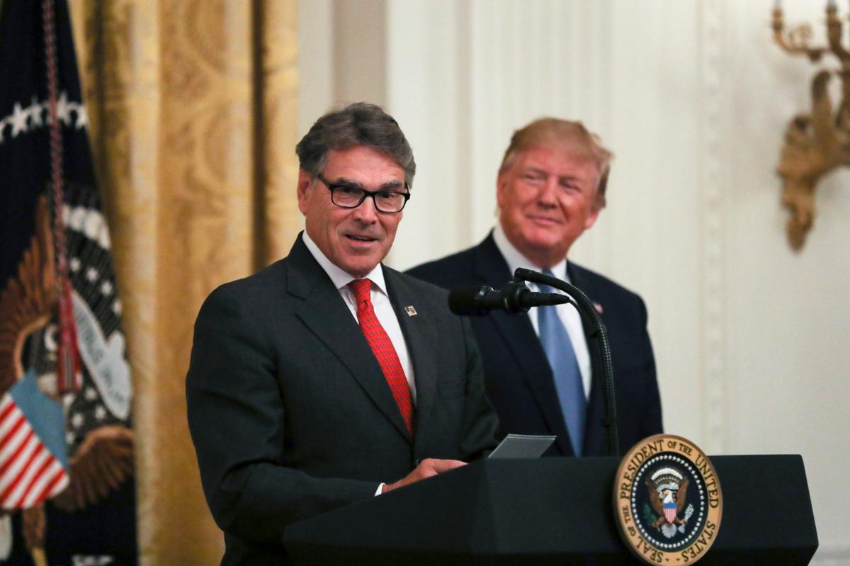 Secretary of Energy Rick Perry and President Donald Trump at the administration's environment initiative event in the East Room of the White House in Washington on July 8, 2019. (Charlotte Cuthbertson/The Epoch Times)