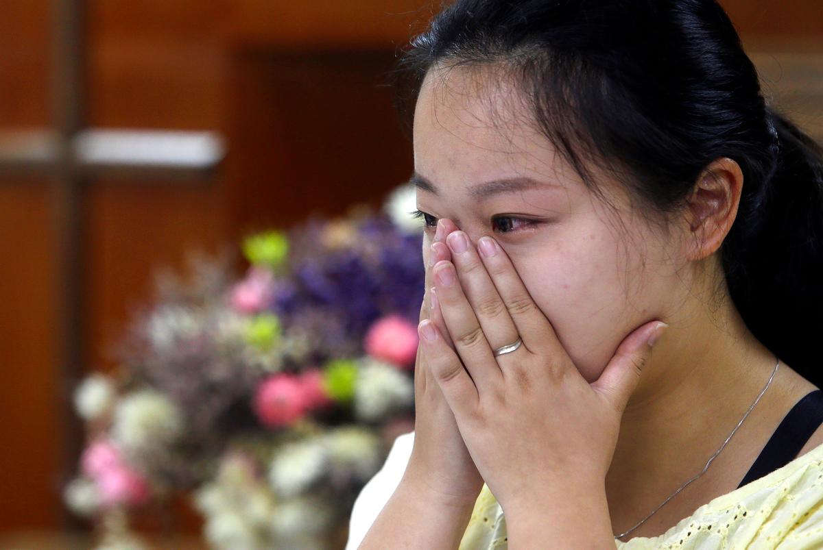 Ren Ruiting, daughter of Liao family, sheds tears as she speak during an exclusive interview with The Associated Press at a church in Taipei, Taiwan on July 7, 2019. (Chiang Ying-ying/AP)