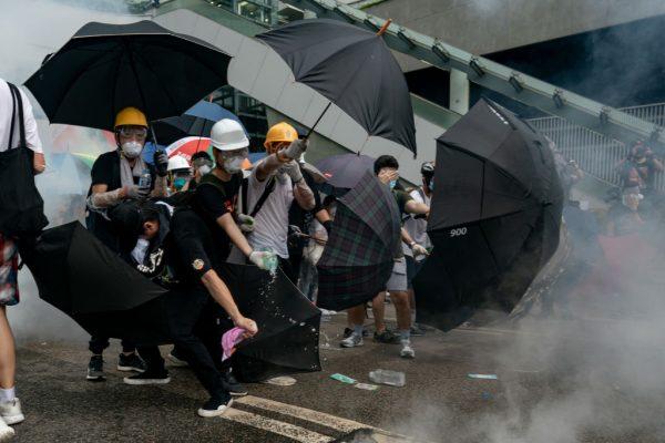 Protesters pour water on to a tear gas canister during a protest in Hong Kong on June 12, 2019. (Anthony Kwan/Getty Images)