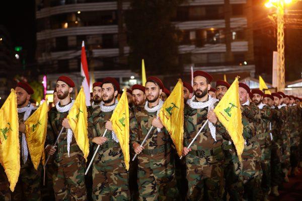 Fighters with the Lebanese Shiite Hezbollah party, carry flags as they parade in a southern suburb of the capital Beirut, to mark the al-Quds (Jerusalem) International Day, on May 31, 2019. (Anwar Amro/AFP/Getty Images)