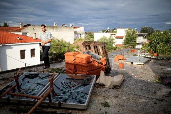 A man walks on a damaged terrace following heavy storms at the village of Nea Plagia, Greece on July 11, 2019. (Alkis Konstantinidis/Reuters)