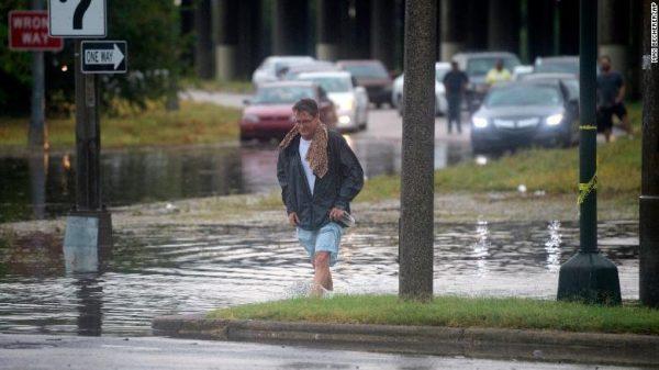 A man walks through standing water in New Orleans. (Max Becherer/AP)