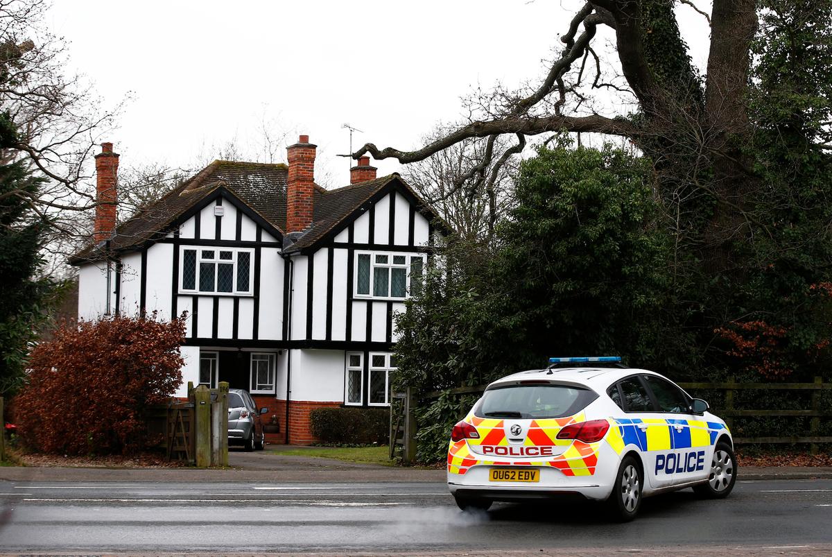 A police car drives past an address that had been linked by local media to former British intelligence officer Christopher Steele, who has been named as the author of an intelligence dossier on President-elect Donald Trump, in Wokingham, Britain, on Jan. 12, 2016. (Reuters/Peter Nicholls)