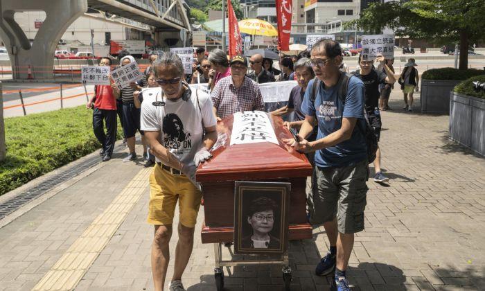 Hong Kong Protesters March With Mock Coffin of City Leader